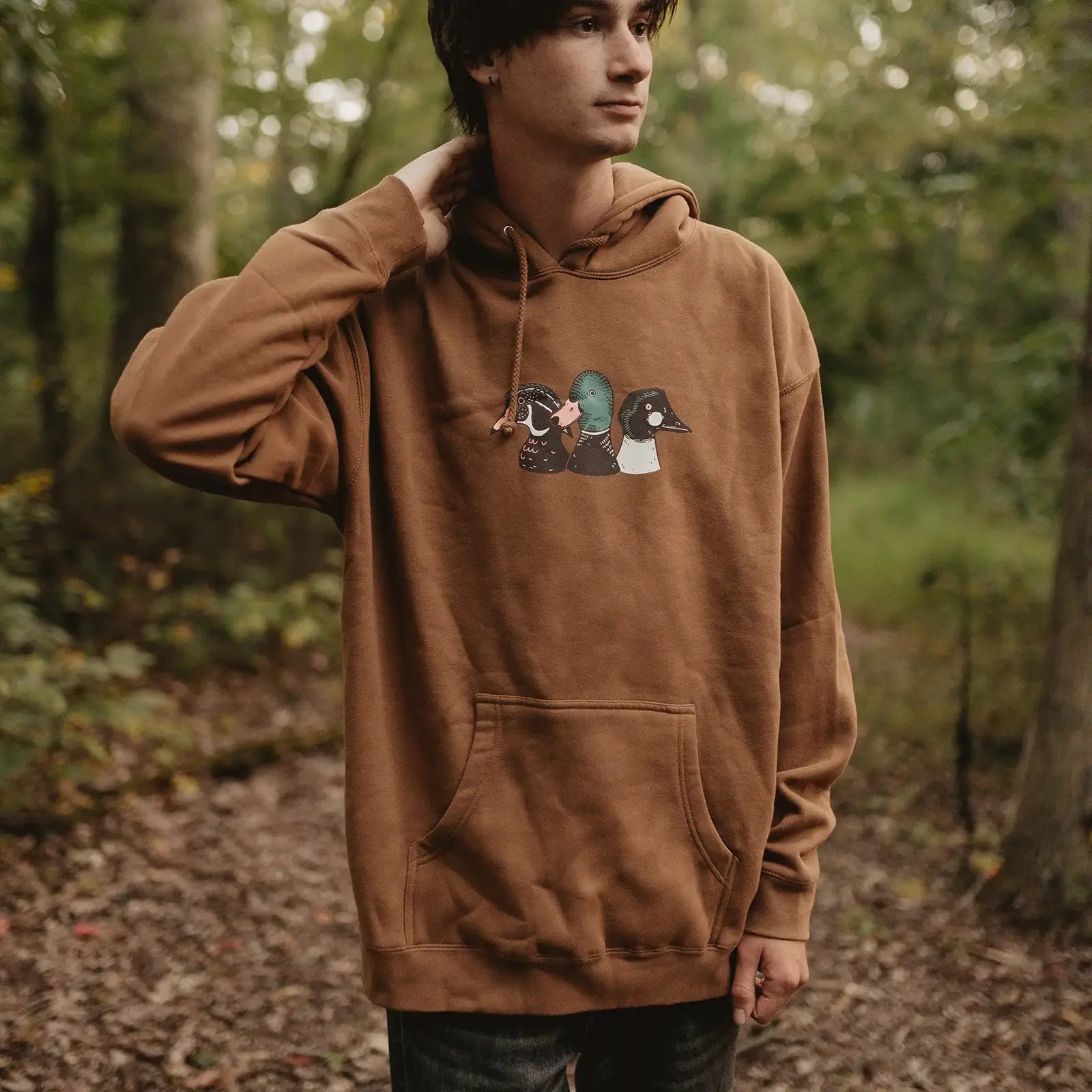 Photo of man wearing Duck Trio Hoodie by Bird Collective will Mallard, Wood Duck, and Common Goldeneye on the front.