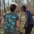 Photo of a man and a women in a park wearing a Bird Collective x American Bird Conservancy Appalachian Woodland T-Shirt