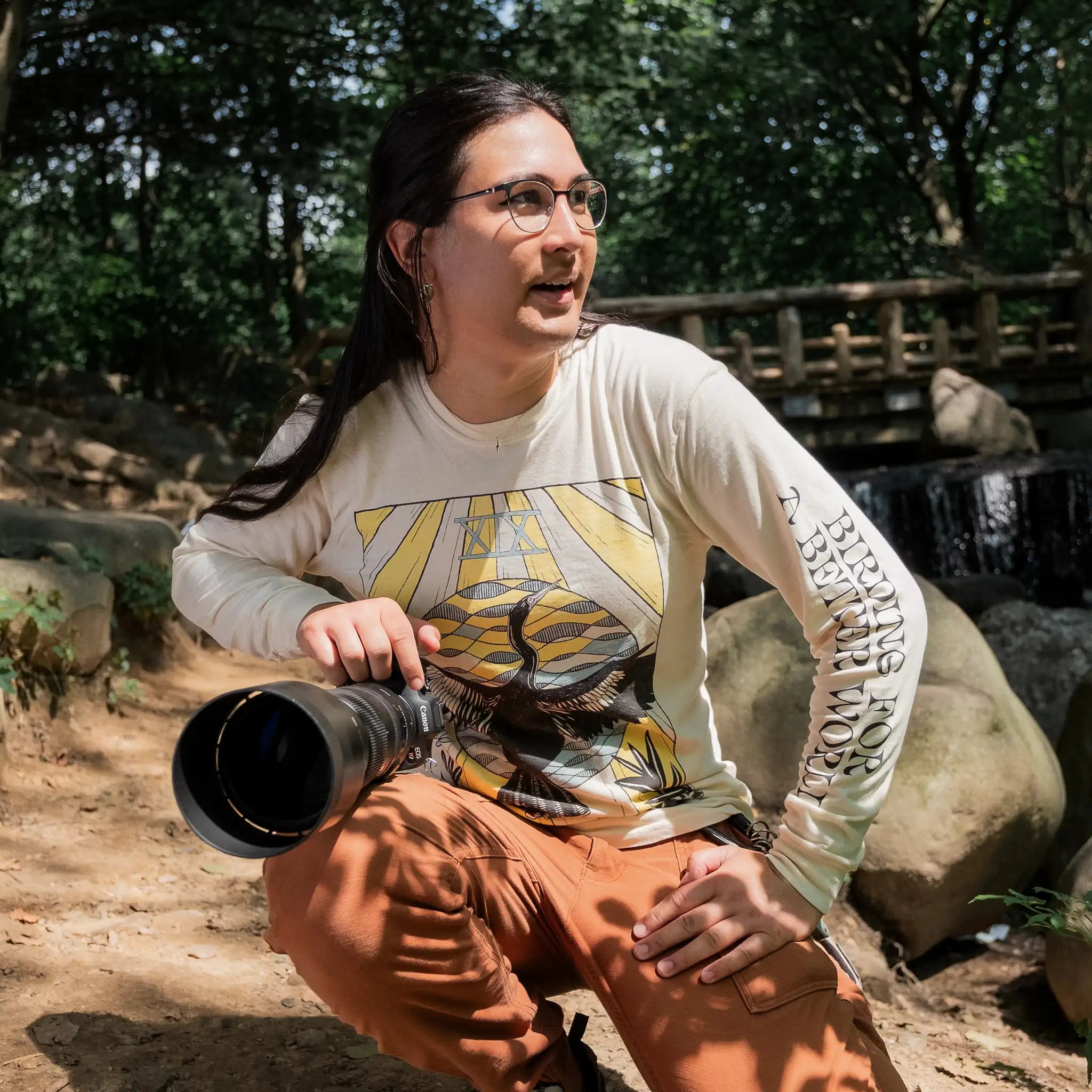 Photo of a person holding a camera and wearing a Bird Collective x Feminist Bird Club Anhinga Tarot Long Sleeve T-Shirt 